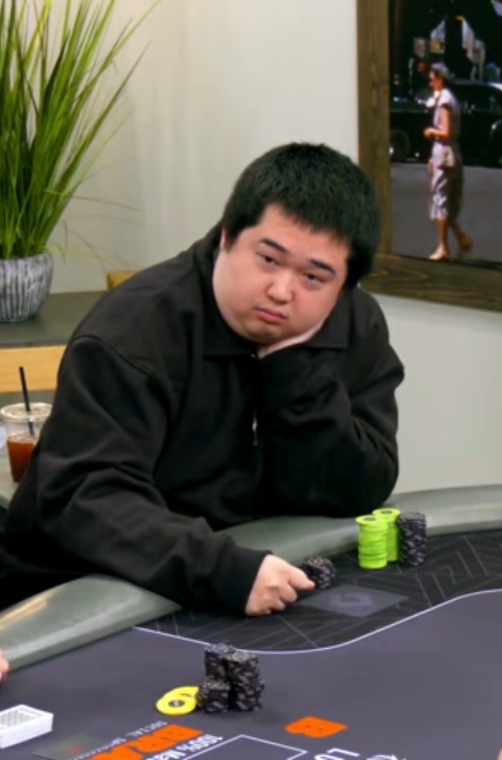 Henry now: a lot rounder, chin in hand at a poker table